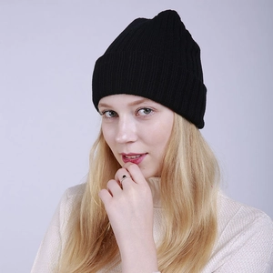 Detailed view of black ribbed knit beanie with thick fold-over cuff for winter warmth