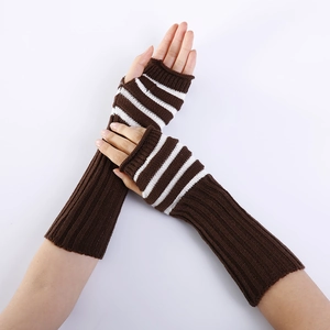 Detail of long knitted fingerless gloves with brown stripes and ribbed wrist warmers