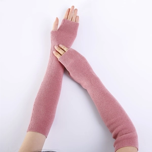 Detail of soft pink cashmere arm warmer showing vertical ribbed knit texture and fingerless design