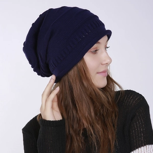 Detailed close-up of dark blue knitted beanie showing striped honeycomb texture and soft yarn