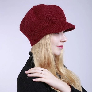 Detailed side view of dark red knitted visor hat with wave texture for winter