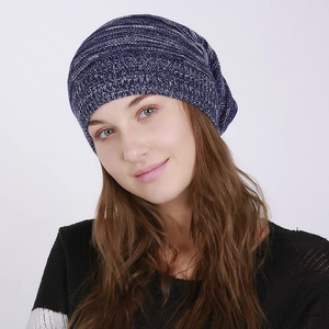 Close-up of blue and white mixed knit slouchy beanie with soft textured winter fabric