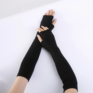 Close-up of black knitted cashmere arm warmers with ribbed cuffs and fingerless design