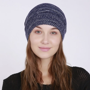 Close-up of navy and white mélange knit texture on a stretchy autumn beanie hat