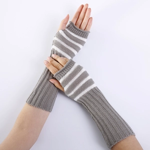 Detail view of grey and white striped knitted fingerless gloves with ribbed cuffs