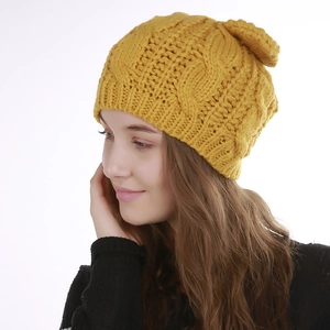 Close-up of ginger yellow cable knit beanie showing thick texture and cute ear details
