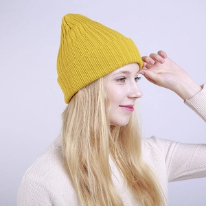 Detail of yellow ribbed knit beanie showing thick texture and soft fit for winter