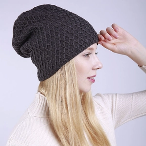 Detalle de gorro de punto gris oscuro con textura de panal y diseño holgado