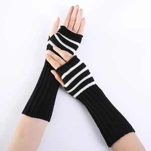 Long knit fingerless gloves with black and white striped patterns and ribbed texture