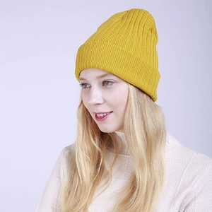 Close-up of ginger yellow ribbed knit beanie with thick fold-over cuff for winter warmth