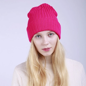 Detail view of pink double-layered ribbed knit beanie on a model for winter warmth