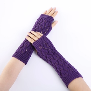 Detail of dark purple knit arm warmers featuring hollow leaf and diamond crochet patterns