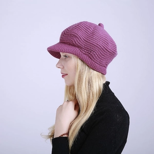 Side view of purple knitted newsboy cap with thick wavy texture and warm brim