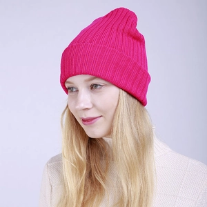 Close-up of rose red ribbed knit beanie showing warm double-layer texture and elasticity