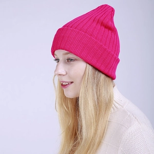 Detail view of pink ribbed knit beanie showing textured stripe pattern and warm double layer