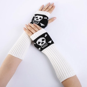 Detail showing white knitted fingerless long gloves with skull pattern on arm warmers