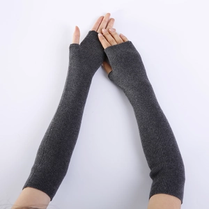Detail of dark grey long fingerless cashmere gloves with elastic ribbed knit texture