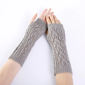 Macro detail of leaf pattern knit texture on taupe fingerless arm warmer gloves