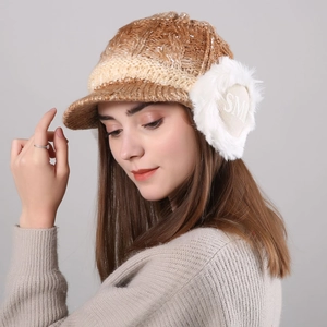 Detail view of winter knitted hat with plush earflaps and gradient lettering pattern