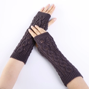 Detailed cable knit pattern on long purple fingerless gloves with hollow leaf design