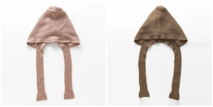 Detail of ribbed knit balaclava scarf featuring soft wool texture and long earflap ties