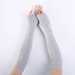 Close-up of light grey ribbed knit fingerless gloves showing long sleeve texture