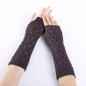 Detail of dark purple knitted arm warmers featuring a delicate hollow leaf pattern mesh