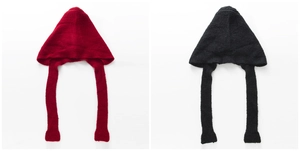 Detail of red and black chunky knit balaclava scarves with long braided earflaps
