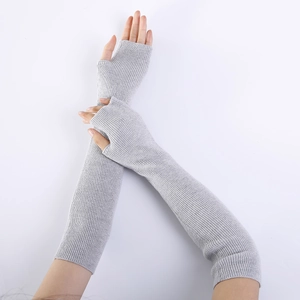 Detail of light grey ribbed knit arm warmer showing textured fabric and fingerless design