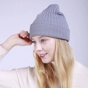 Detail of light grey ribbed knit beanie showing thick texture and soft vertical stripes