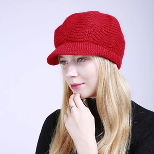 Macro view of wave knit texture and soft ribbed brim on this red winter baker boy hat