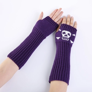 Detail of purple knitted fingerless gloves with white skull and crossbones pattern