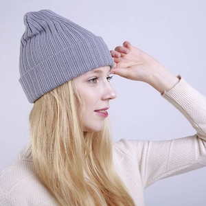 Detail view of the rib-knit pattern and light grey texture on a winter beanie hat