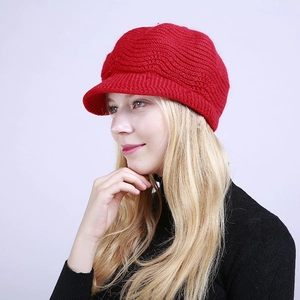 Detailed knit texture of a warm red knitted beret hat for winter season fashion