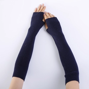 Detail of dark blue knit fingerless gloves showing long arm sleeve and rib texture