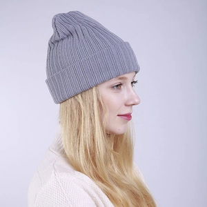 Close-up of light gray ribbed knit beanie showing vertical stripe texture and wide cuff