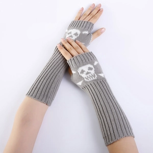 Detail of grey knitted arm warmer featuring white skull and crossbones graphic pattern