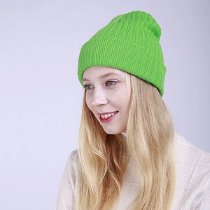 Detail of bright green ribbed knit beanie with thick fold-over cuff for winter