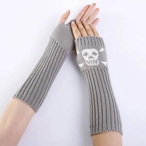 Detail of grey knitted fingerless gloves with white skull print and ribbed texture