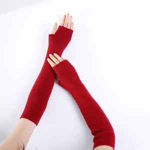 Macro detail of dark red ribbed knit texture on soft cashmere long fingerless gloves