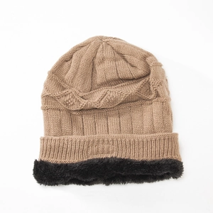 Detail of winter knit hat featuring khaki diamond weave and thick black fleece lining