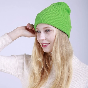 Detail view of grass green rib-knit beanie showing thick ribbed texture and elasticity