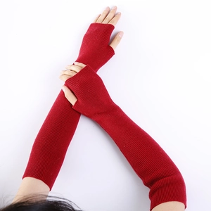 Close-up of long dark red ribbed knit arm warmers with fingerless design for winter