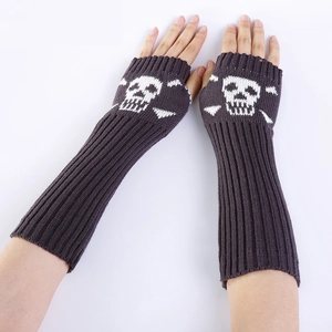 Detail of dark grey knit fingerless gloves with white skull pattern and ribbed cuffs