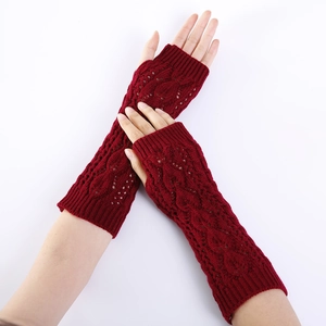 Detail of dark red hollow-out leaf knit fingerless arm warmers with ribbed cuffs