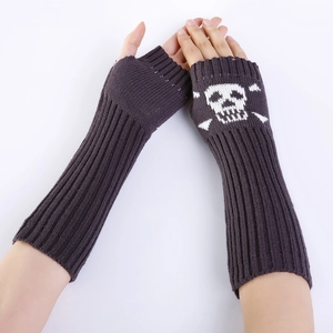 Detail of grey knitted fingerless gloves featuring white skull and crossbones pattern