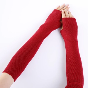 Detail of red vertical ribbed knit texture on long fingerless cashmere arm warmers