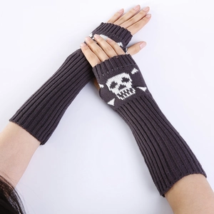 Detail view of dark grey knitted fingerless gloves featuring white skull and crossbones