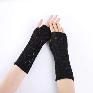 Close-up of black cable knit arm warmers featuring an elegant hollow leaf pattern