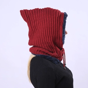 Detail of red knit hat with navy faux fur lining and adjustable drawstring closure